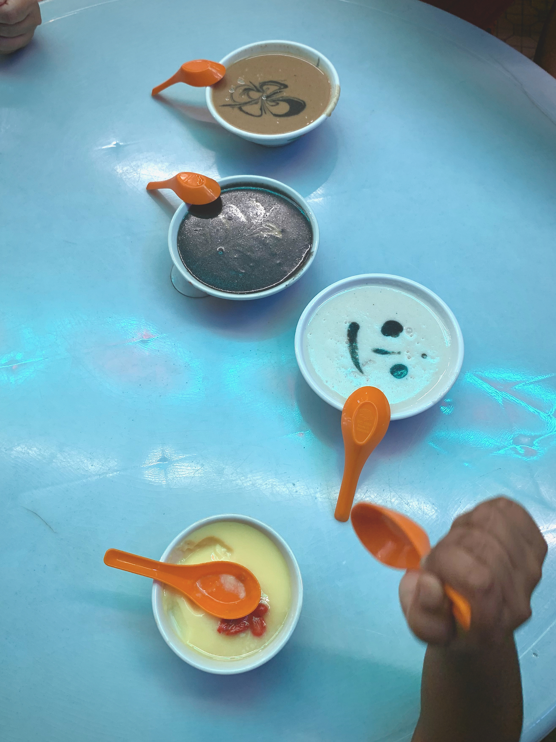 Cups of the desserts made out of pastes of Black Sesame, Walnut, Peanut and Almond